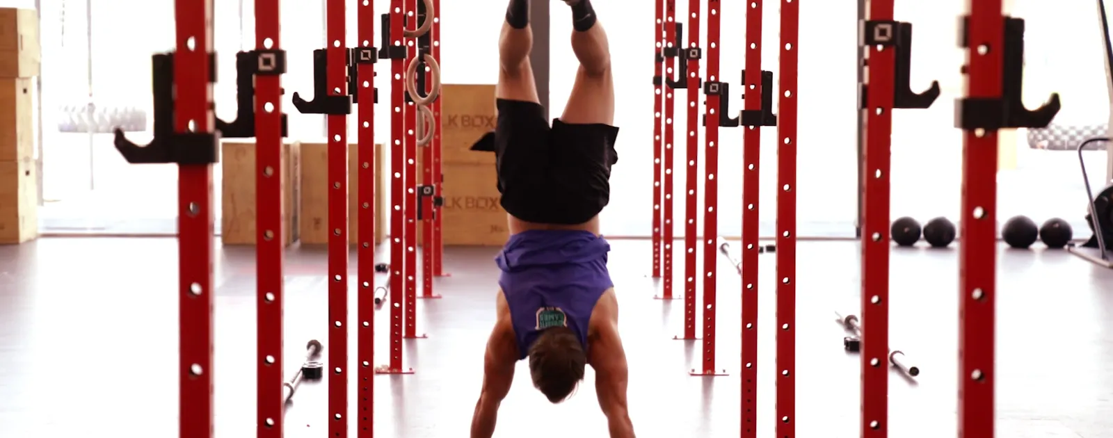 a guy is standing upside down to stretch his upper body
