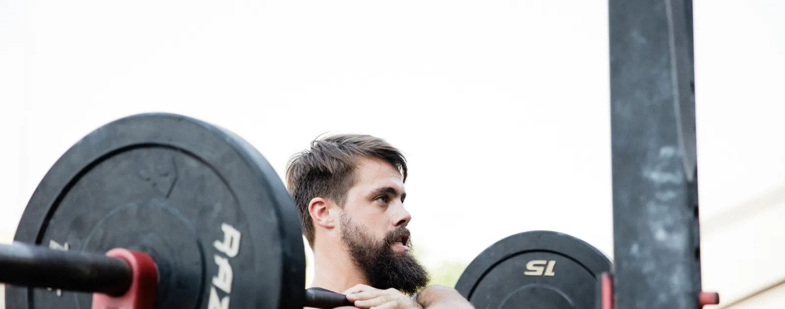 a grown man with beard is lifting heavy weights