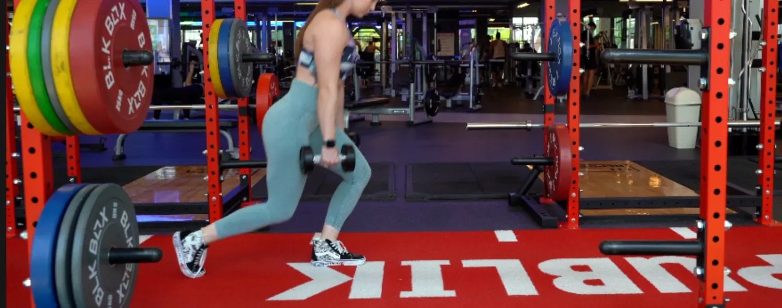 a woman lifting weights in FitRepublik’s functional zone