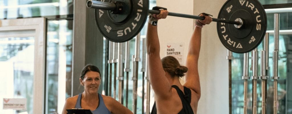 a woman is powerlifting as per woman's instructions